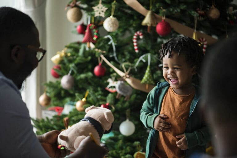 child with christmas tree after parents separation