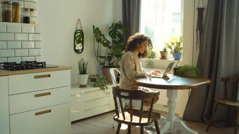 Woman in kitchen researching Spousal Maintenance
